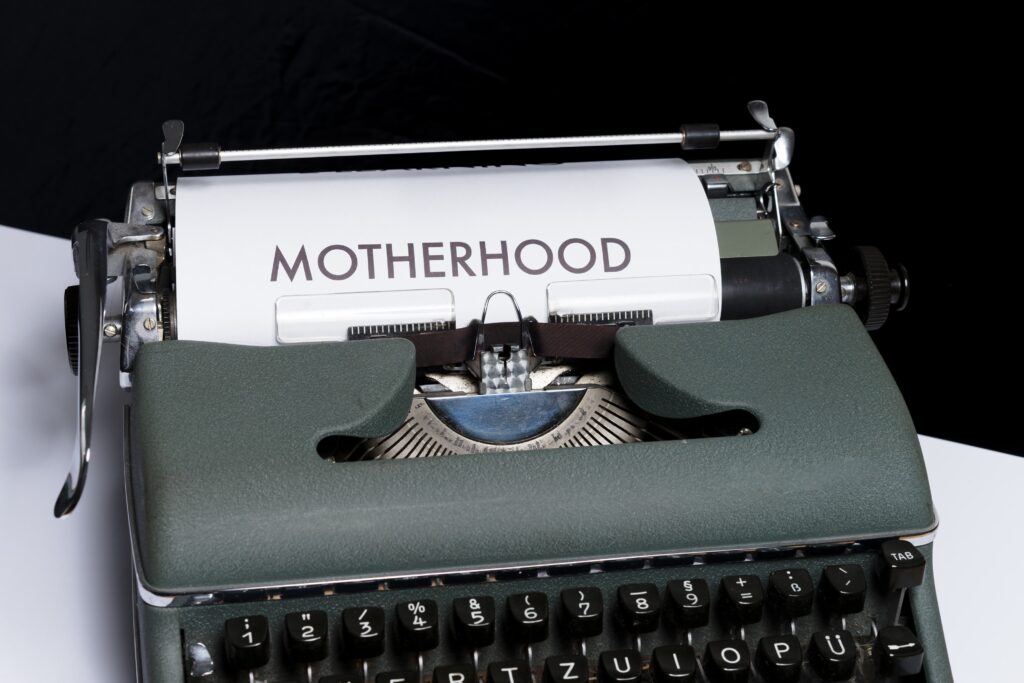 Typewriter with 'Motherhood' typed